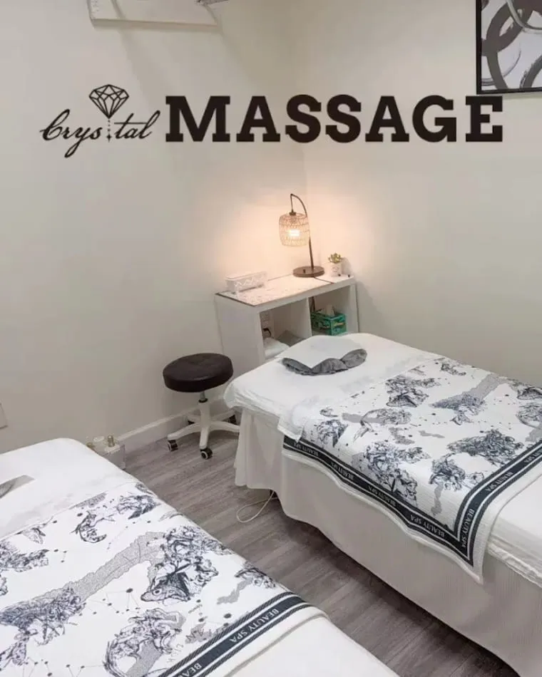A treatment room at Crystal Massage in Wichita, Kansas, the table made up and the lamps low